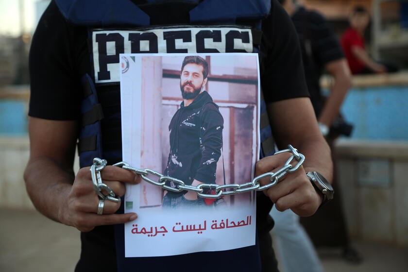 Syrian journalists protest after a colleague was arrested in northern Syria