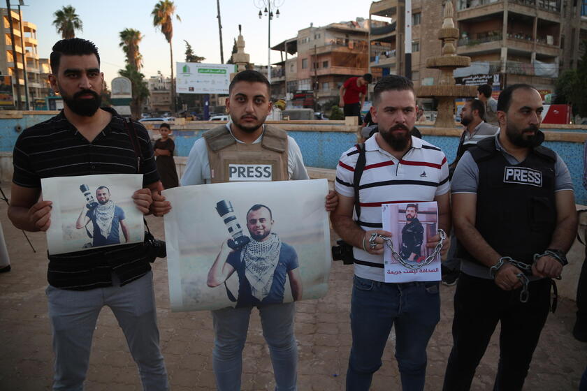 Syrian journalists protest after a colleague was arrested in northern Syria