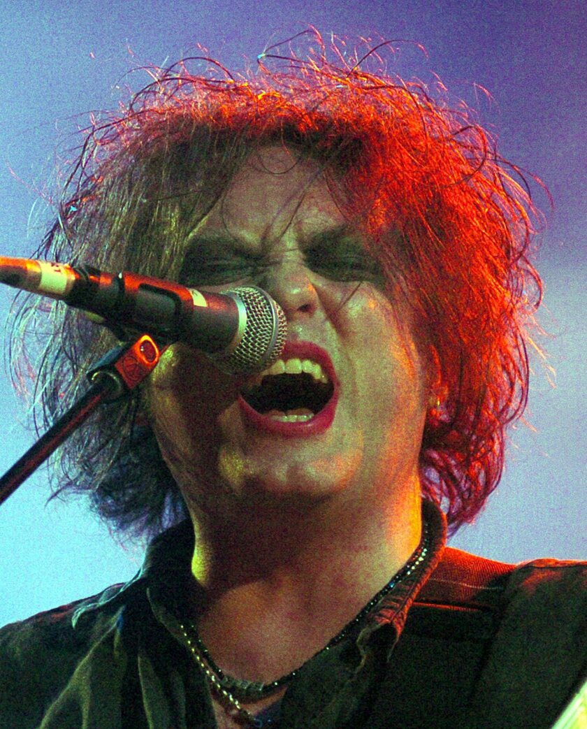 British singer and guitarist Robert Smith of the group   The Cure   performs